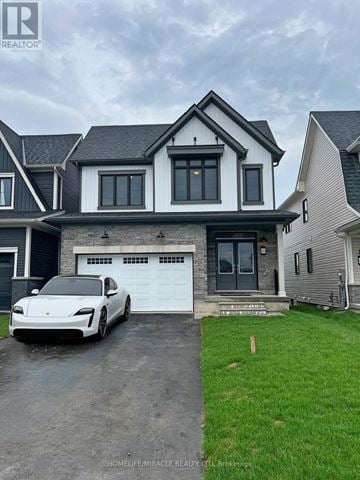 Welland (Dain City) apartment for rent - A white car is parked in front of a two-story house.