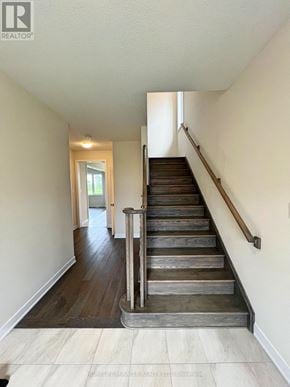 Welland (Dain City) apartment for rent - A staircase with wooden steps and a metal handrail.