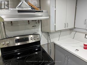 Erin apartment for rent - A kitchen with a stove and cabinets.