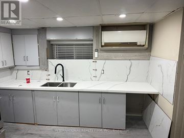 Erin apartment for rent - A kitchen with a marble counter top and stainless steel cabinets.