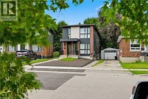 Brantford apartment for rent - A residential area with houses and parked cars.