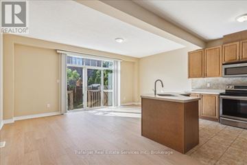 Oakville (Wm Westmount) townhouse for rent - A kitchen area with wooden cabinets and a countertop.