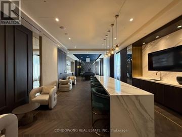 Vaughan (Vaughan Corporate Centre) condo for rent - A modern living room with a long white marble table and white chairs.