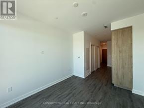 Vaughan (Vaughan Corporate Centre) condo for rent - A room with a wooden floor and white walls, with a door on the right side.