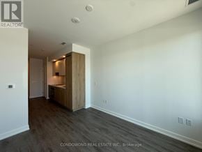 Vaughan (Vaughan Corporate Centre) condo for rent - A room with a wooden cabinet and a white wall.