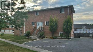 St. Catharines (Burleigh Hill) triplex for rent - A brick building with a tree in front of it.