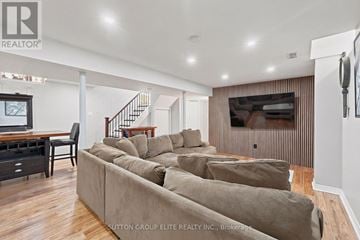 Mississauga (Erin Mills) apartment for rent - A living room with a row of couches and a television.