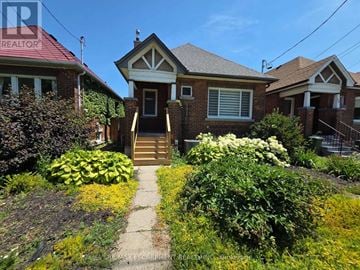 Hamilton (Westdale) apartment for rent - A house with a red roof and a garden in front.
