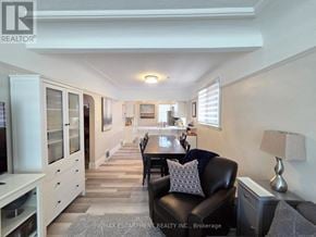 Hamilton (Westdale) apartment for rent - A well-lit dining area with a table set for two and a couch with a pillow.