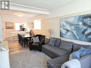 Hamilton (Westdale) apartment for rent - A living room with a grey couch and a painting on the wall.