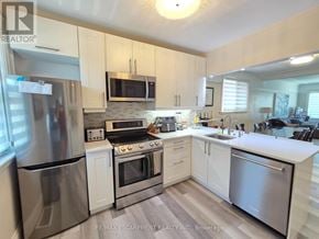 Hamilton (Westdale) apartment for rent - A kitchen with white cabinets and stainless steel appliances.