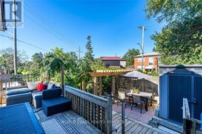 Toronto (Birchcliffe-Cliffside) apartment for rent - A sunny day at a backyard with a wooden deck and patio furniture.