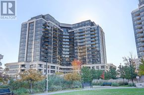 Toronto (York University Heights) condo for rent - A large building with many windows is surrounded by trees and a park.