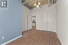 Windsor apartment for rent - A room with a blue wall and wooden flooring.