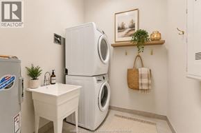 Windsor apartment for rent - A small white sink is in a laundry room with a washer and dryer.