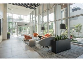 Surrey apartment for rent - A modern office lobby with a large glass wall and a variety of seating options.