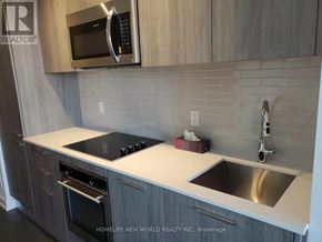 Toronto (Church-Yonge Corridor) condo for rent - A modern kitchen with a stove top oven and microwave above it.