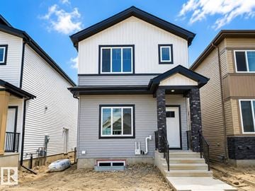 Leduc apartment for rent - A modern house with a grey front and a white door.
