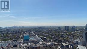 Toronto (University) condo for rent - A cityscape with buildings and a clear sky.