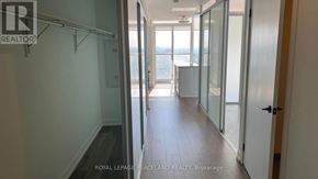 Toronto (University) condo for rent - A hallway with a glass door leading to a balcony.