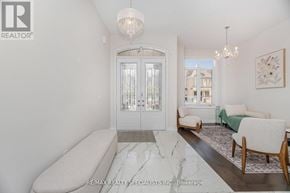 Oakville (Go Glenorchy) apartment for rent - A white interior with a chandelier, a sofa, and a table.