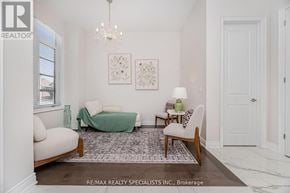 Oakville (Go Glenorchy) apartment for rent - A well-lit, spacious living room with a sofa, a chair, and a rug.