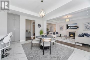 Oakville (Go Glenorchy) apartment for rent - A modern living room with a fireplace and a dining table set up.