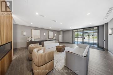 Hamilton (Waterdown) house for rent - A modern living room with a large couch and a television.