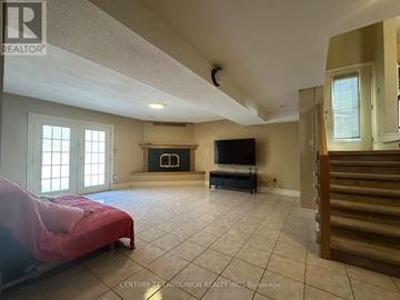 Hamilton (Mountview) apartment for rent - A bedroom with a bed covered in a pink sheet and a television in the corner.