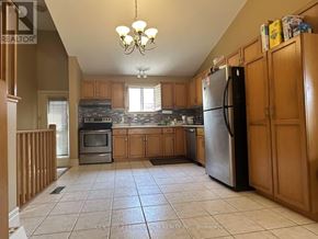 Hamilton (Mountview) apartment for rent - A kitchen with tile flooring and a refrigerator.