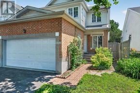 Ottawa apartment for rent - A house with a white garage door and brick exterior.