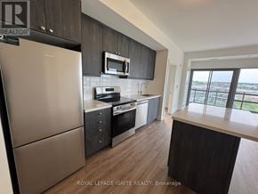 Clarington (Bowmanville) condo for rent - A kitchen with a refrigerator, microwave, oven, and sink.
