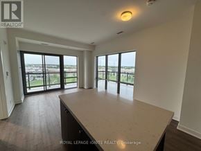 Clarington (Bowmanville) condo for rent - A spacious room with a large window overlooking a cityscape.