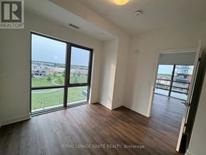 Clarington (Bowmanville) condo for rent - A room with a large window overlooking a green area.