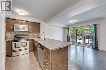 Mississauga (Churchill Meadows) townhouse for rent - A kitchen with a stove top oven, microwave, and dishwasher.