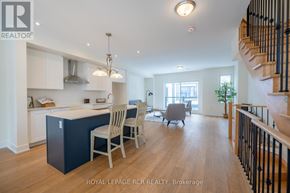 Orillia townhouse for rent - A spacious kitchen with a dining area and a staircase.