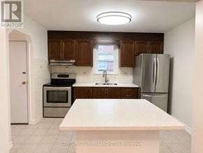 Toronto (Birchcliffe-Cliffside) apartment for rent - A kitchen with a refrigerator, sink, and oven.