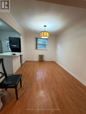 Toronto (Birchcliffe-Cliffside) apartment for rent - A wood floor in a room with a chair and a window.