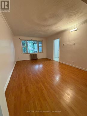 Toronto (Birchcliffe-Cliffside) apartment for rent - A room with wooden floors and a window with blinds.
