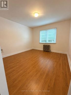 Toronto (Birchcliffe-Cliffside) apartment for rent - A room with wooden flooring and a window with blinds.