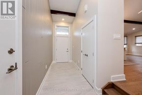 New Tecumseth multi-family for rent - A hallway with white doors and a wooden floor.