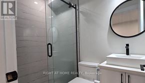 Ottawa apartment for rent - A bathroom with a sink, mirror, and toilet.