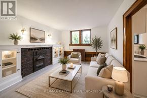 Toronto (Woodbine Corridor) condo for rent - A well-lit living room with a fireplace and a couch.