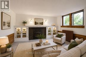 Toronto (Woodbine Corridor) condo for rent - A well-lit living room with a fireplace and a couch.