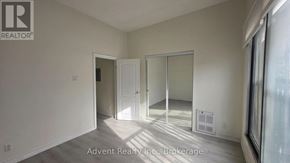 Toronto (Roncesvalles) apartment for rent - A room with a white door and a white wall with a window.