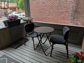 Toronto (Palmerston-Little Italy) apartment for rent - A small table and two chairs are on a porch.