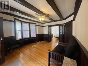 Toronto (Palmerston-Little Italy) apartment for rent - A room with wooden floors and a ceiling fan.