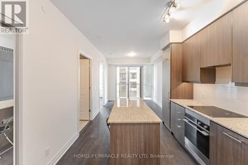 Mississauga (Fairview) condo for rent - A kitchen with wooden cabinets and a marble countertop.