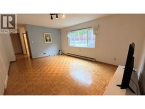 Vancouver apartment for rent - A living room with a wooden floor and a television.