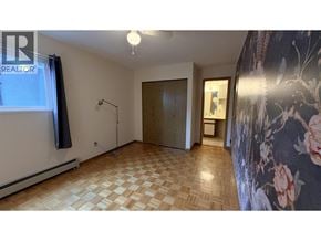 Vancouver apartment for rent - A room with a checkered floor and a wallpapered wall.